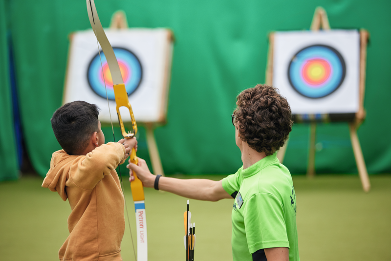 Kids participating in an archery activity